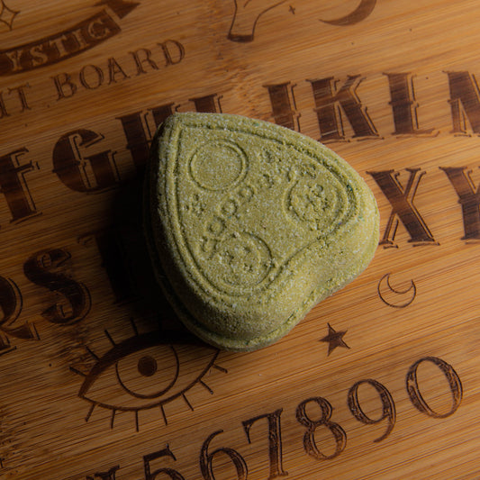 pale green bath bomb shaped like a planchette