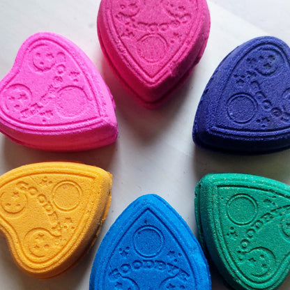 six planchette shaped bath bombs in rainbow colors