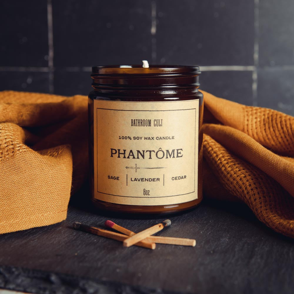 amber glass candle reading phantom; sage, lavender, cedar notes listed